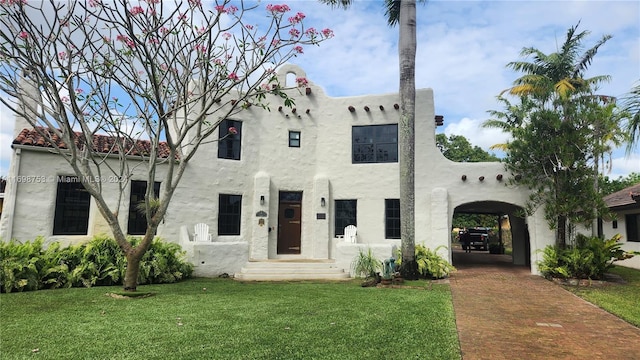 view of front of house with a front yard and a carport