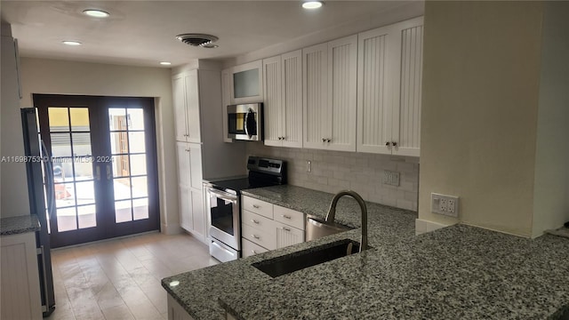 kitchen featuring french doors, stainless steel appliances, and white cabinetry