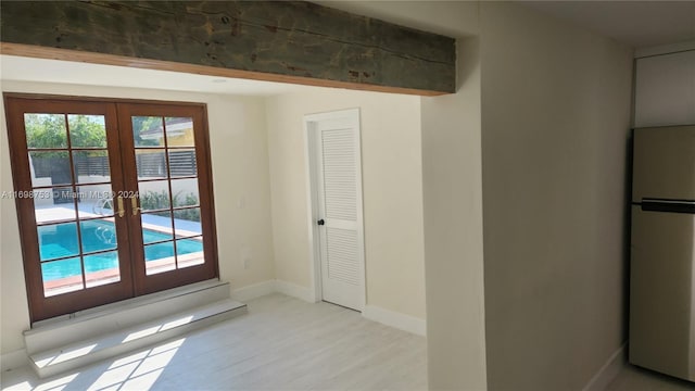 doorway to outside with french doors and light hardwood / wood-style flooring