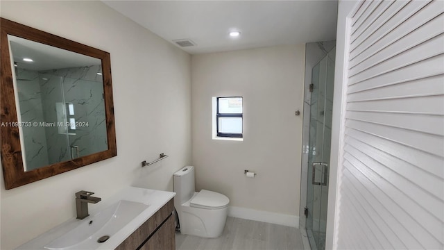 bathroom with walk in shower, hardwood / wood-style flooring, vanity, and toilet