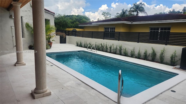 view of swimming pool with a patio