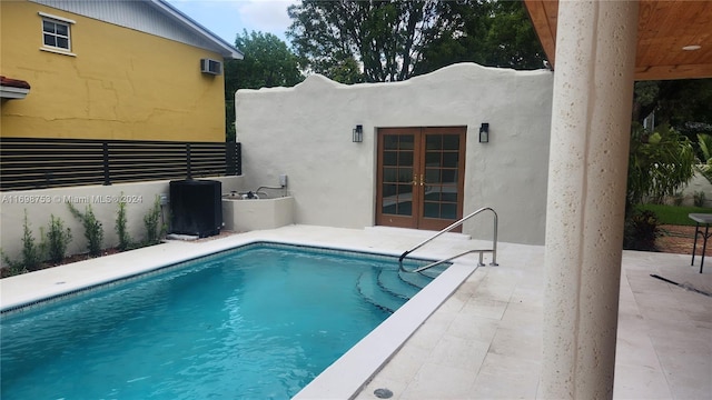 view of pool featuring french doors, central AC, and a patio area