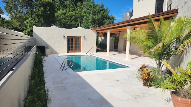 view of pool featuring ceiling fan, a patio area, and french doors