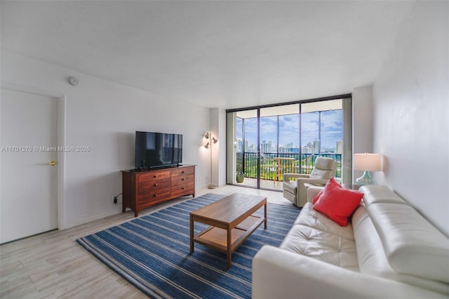 living room featuring hardwood / wood-style flooring and a wall of windows