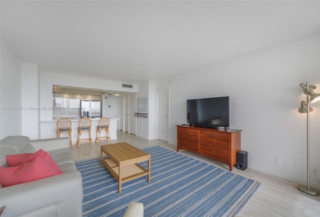 living room with light hardwood / wood-style flooring