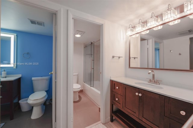 full bathroom with vanity, toilet, and bath / shower combo with glass door