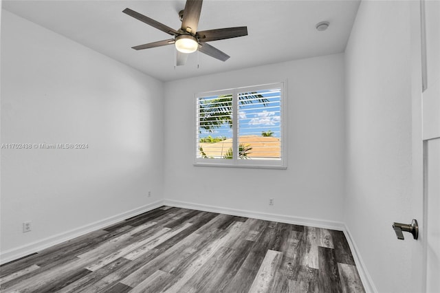 spare room featuring ceiling fan and dark hardwood / wood-style floors