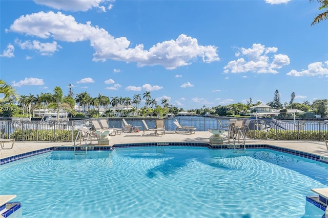 view of pool with a water view and a patio area