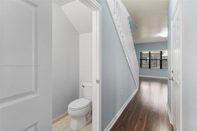 bathroom featuring hardwood / wood-style floors and toilet