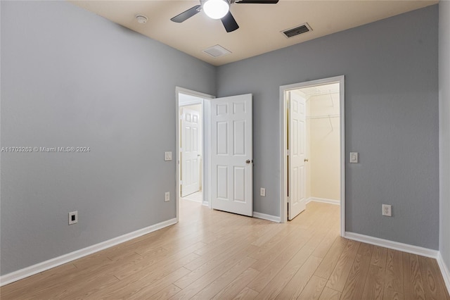 unfurnished room featuring light wood-type flooring and ceiling fan