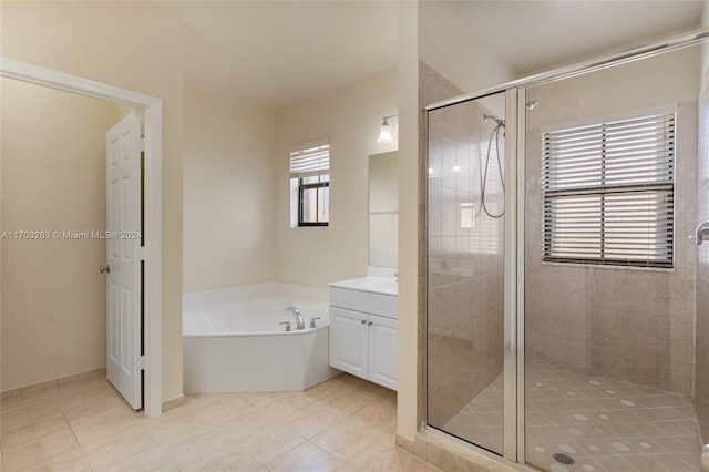 bathroom with tile patterned flooring, vanity, and shower with separate bathtub