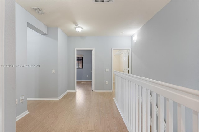 corridor with light hardwood / wood-style flooring