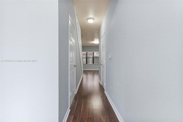 hall with dark hardwood / wood-style floors