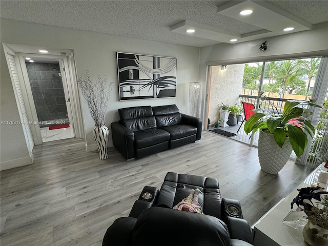 living room with hardwood / wood-style floors and a textured ceiling