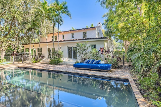 view of pool with french doors and a patio