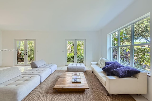 tiled living room featuring french doors and a wealth of natural light