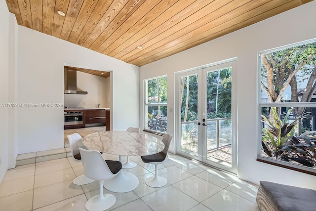 dining space with vaulted ceiling, wooden ceiling, light tile patterned floors, and french doors