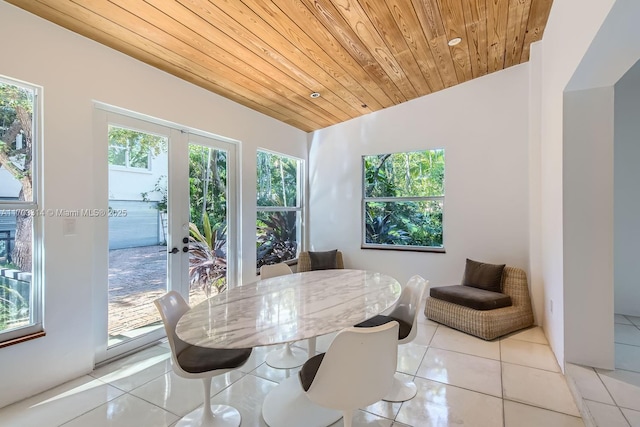 tiled dining room with french doors, lofted ceiling, and wooden ceiling