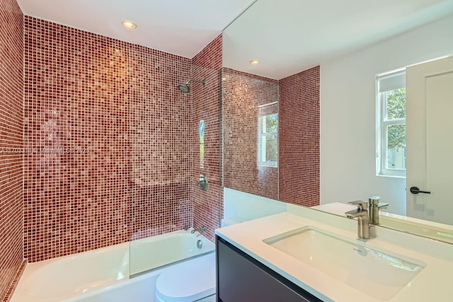 full bathroom with vanity, toilet, and tiled shower / bath