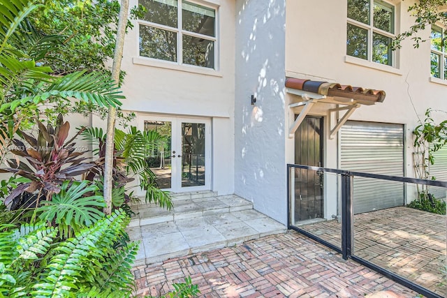 property entrance with a patio area and french doors