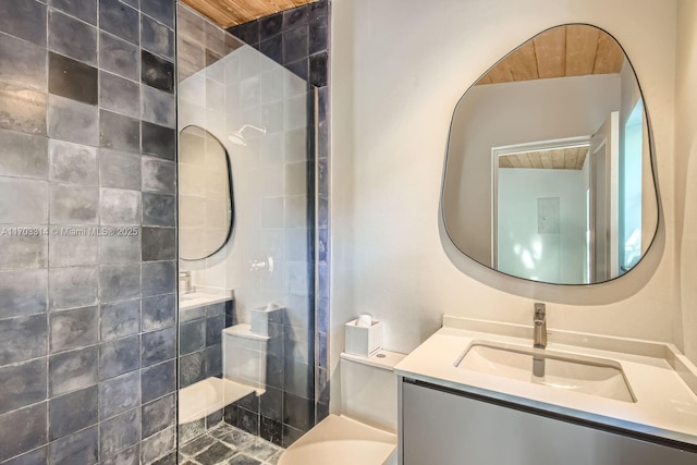 bathroom with vanity, wooden ceiling, and tiled shower