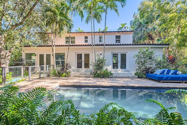 rear view of house with a patio and french doors