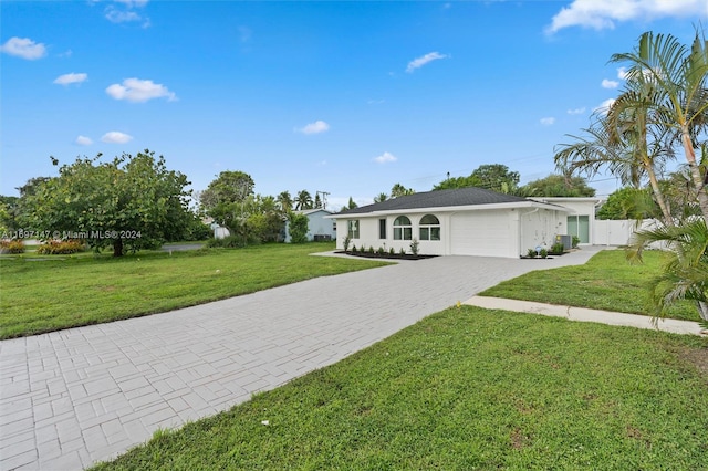 single story home with a garage and a front lawn