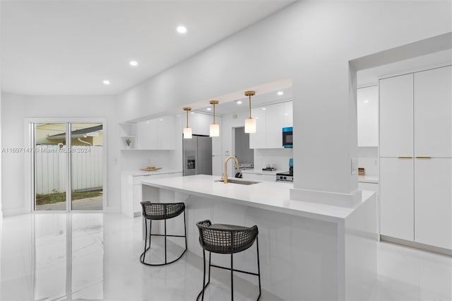 kitchen with a center island with sink, decorative light fixtures, white cabinetry, and stainless steel fridge with ice dispenser