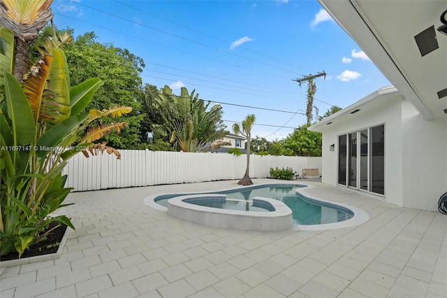 view of swimming pool featuring an in ground hot tub and a patio