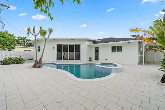 view of swimming pool with a patio area and an in ground hot tub