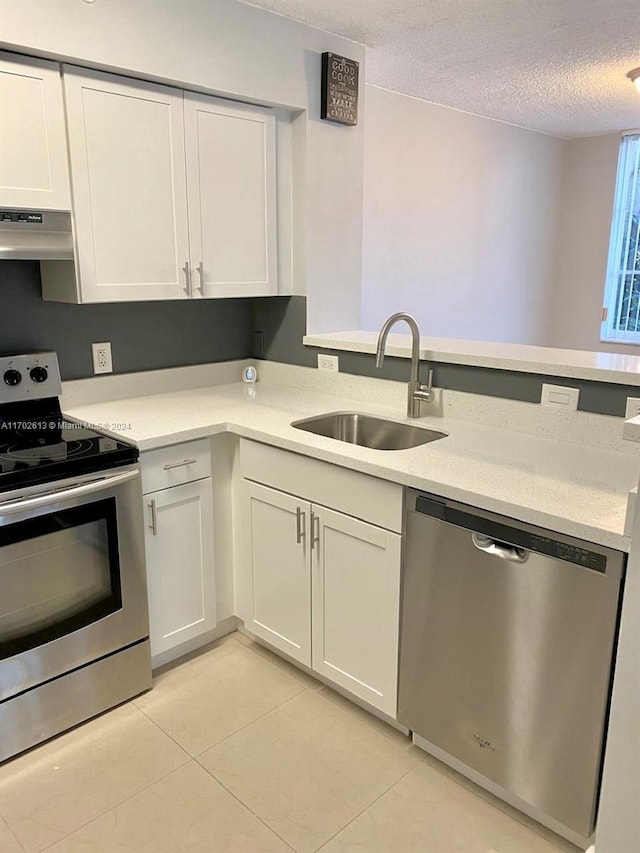 kitchen featuring sink, stainless steel appliances, a textured ceiling, white cabinets, and exhaust hood