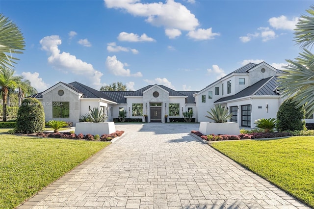 1410 Shadow Meadow Ln, Deland, FL 32724 - view of front facade with a standing seam roof, decorative driveway, stucco siding, and metal roof