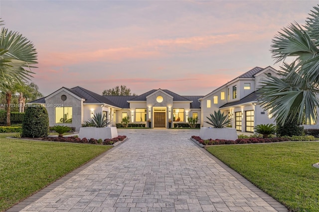 1410 Shadow Meadow Ln, Deland, FL 32724 - view of front facade featuring curved driveway, stucco siding, and a front lawn