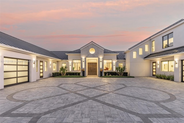 1410 Shadow Meadow Ln, Deland, FL 32724 - view of front facade featuring a standing seam roof, metal roof, decorative driveway, and a garage