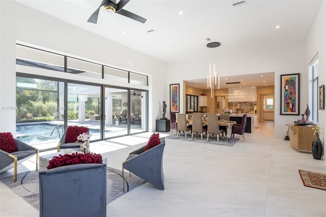 1410 Shadow Meadow Ln, Deland, FL 32724 - living area with light marble finish flooring, ceiling fan, a towering ceiling, and recessed lighting