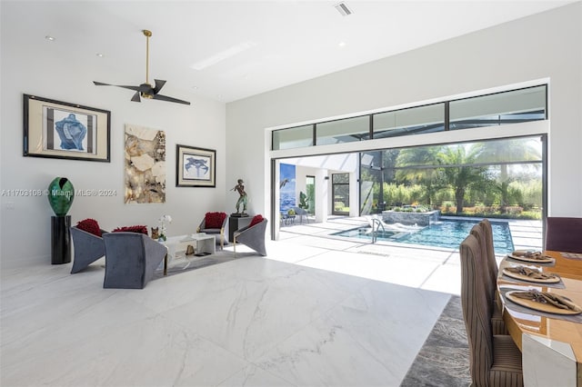 living room featuring ceiling fan and plenty of natural light