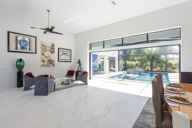 1410 Shadow Meadow Ln, Deland, FL 32724 - living room with healthy amount of natural light, ceiling fan, marble finish flooring, and a towering ceiling