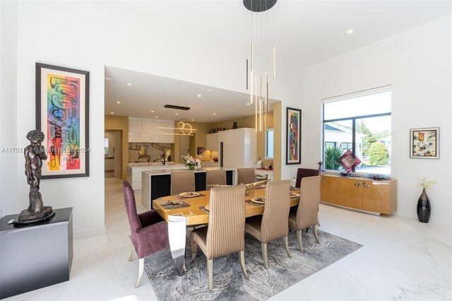 1410 Shadow Meadow Ln, Deland, FL 32724 - dining space with recessed lighting, a high ceiling, and light marble finish flooring
