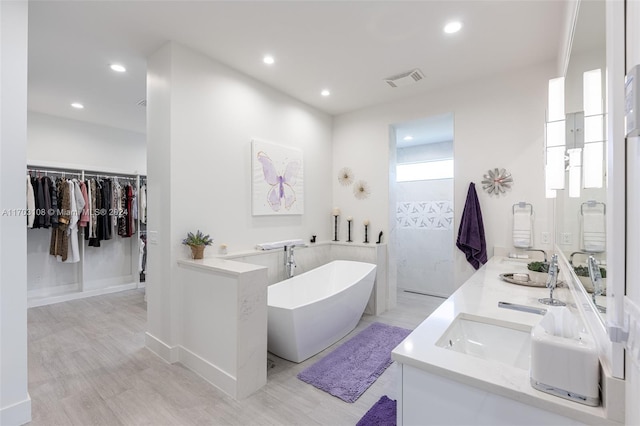 bathroom featuring vanity and separate shower and tub