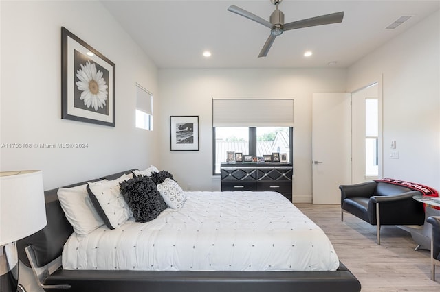 bedroom with ceiling fan and light hardwood / wood-style floors