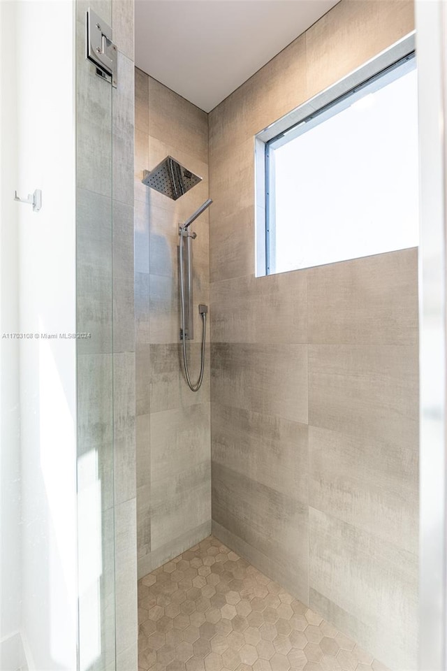 bathroom with a tile shower