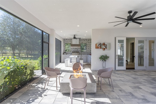 sunroom featuring plenty of natural light and french doors