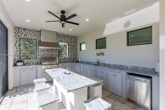 1410 Shadow Meadow Ln, Deland, FL 32724 - kitchen with wall chimney range hood, dishwasher, a ceiling fan, a sink, and a center island