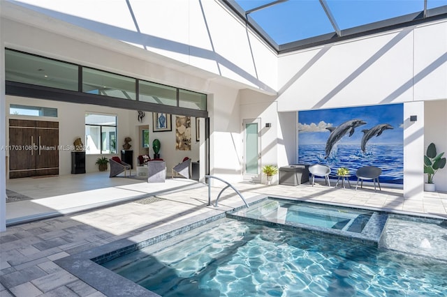 view of pool featuring an in ground hot tub, a lanai, and a patio area