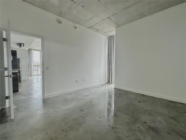 spare room with concrete flooring