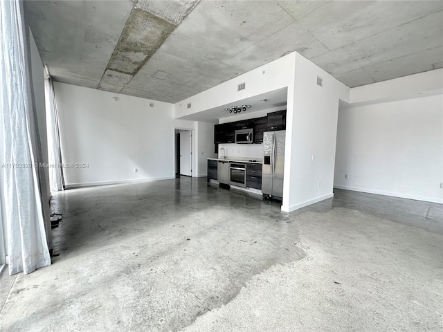 unfurnished living room with sink