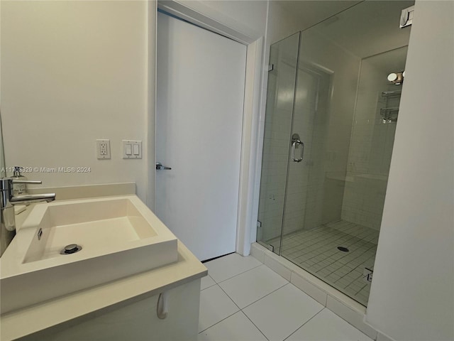 bathroom with tile patterned floors, vanity, and an enclosed shower