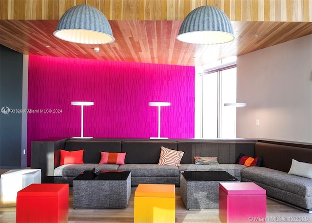 living room featuring light hardwood / wood-style flooring and wooden ceiling