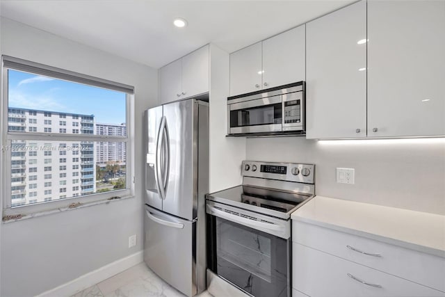 kitchen featuring white cabinets and appliances with stainless steel finishes