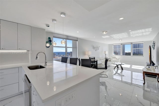 kitchen featuring sink, pendant lighting, and stainless steel dishwasher